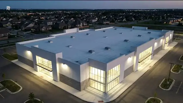 Still from the ROSE film for Retail: an aerial of a big box retail store at dusk, full roof in frame.